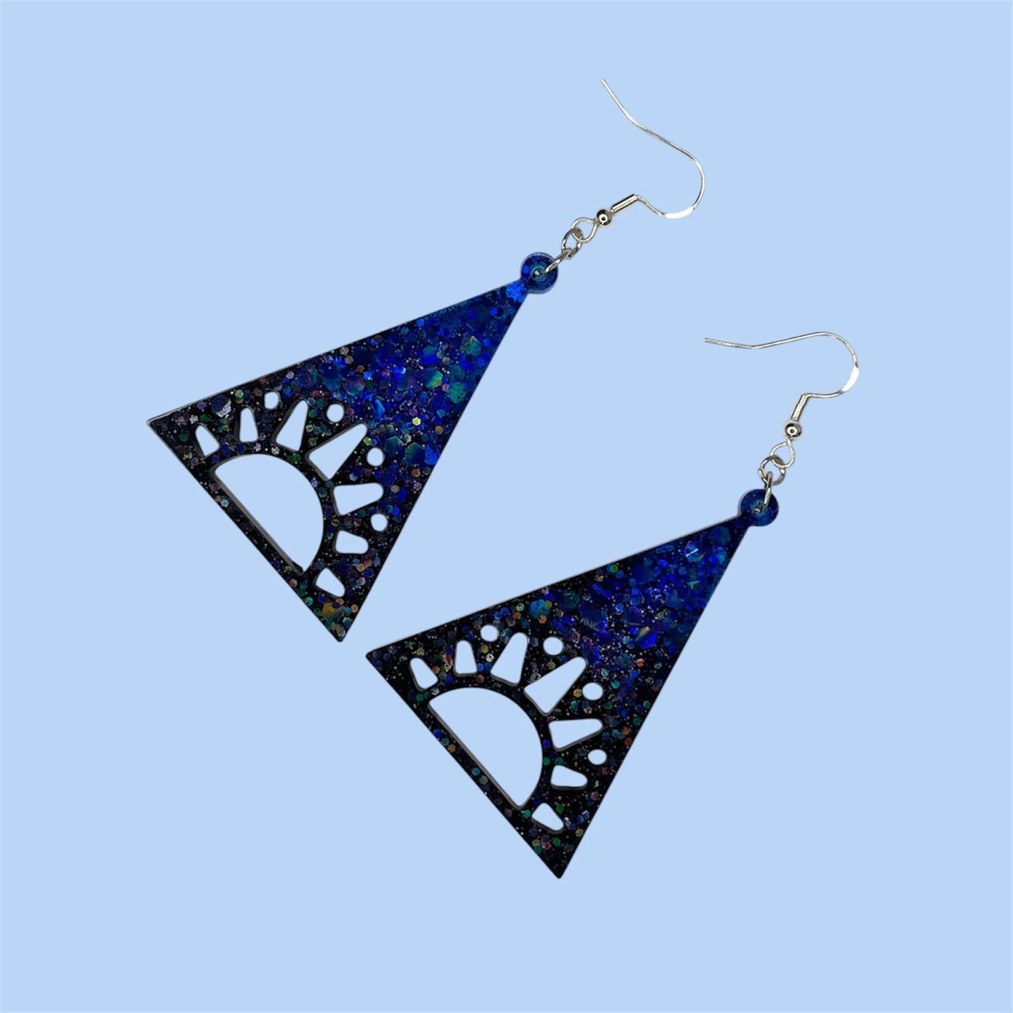 Cosmic vibes dangle drop glittery earrings in black, purple and blue. Silver plated hardware
