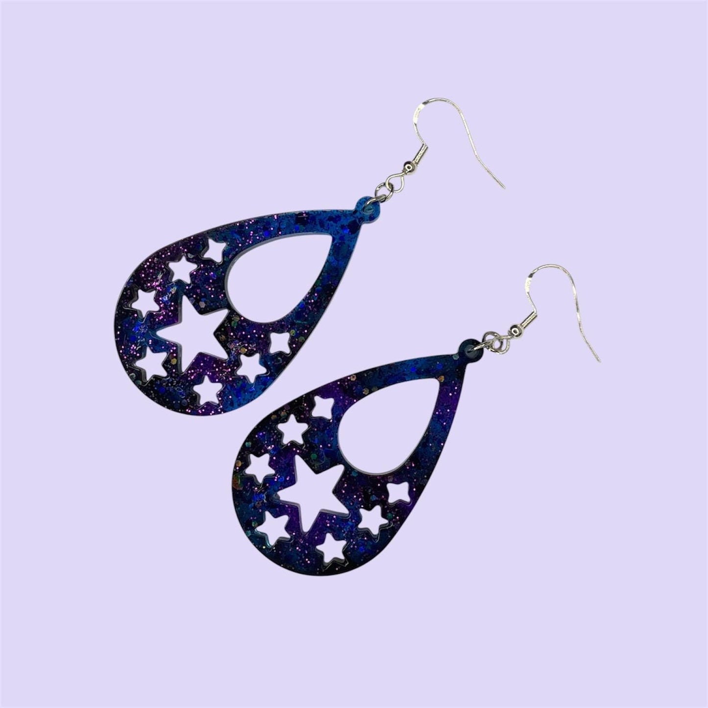 Cosmic vibes dangle drop glittery earrings in black, purple and blue. Silver plated hardware