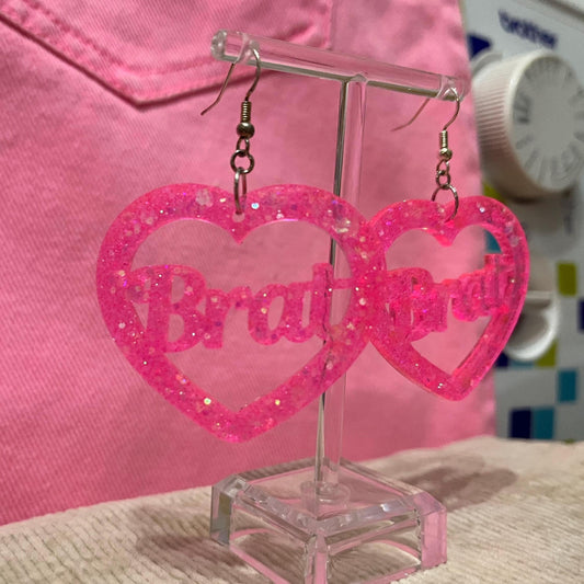Pink glitter bitch or brat dangle drop earrings or clip ons