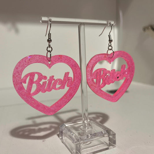 Pink glitter bitch or brat dangle drop earrings or clip ons