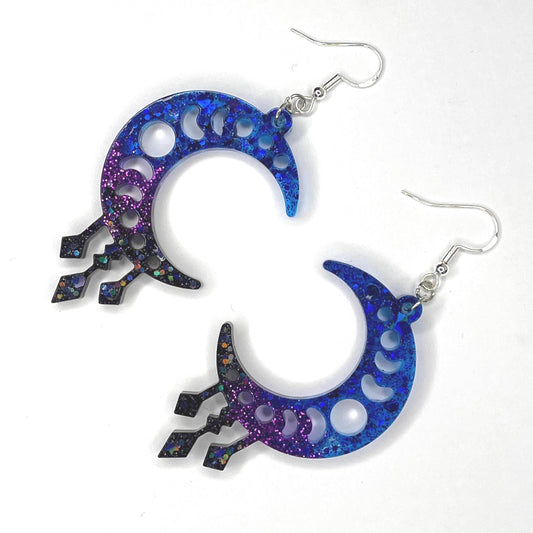 Cosmic vibes dangle drop glittery earrings in black, purple and blue. Silver plated hardware